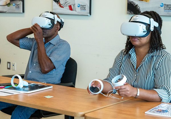 sust-1 Two participants in SAGE Jamaica experience virtual reality headsets